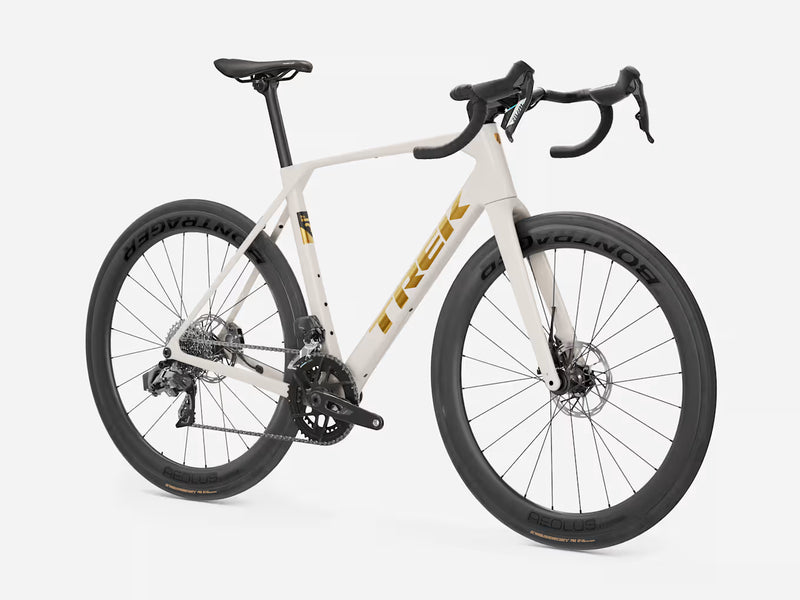 A white Trek road endurance bicycle with black components, drop handlebars, and black wheels, shown from a three-quarters front angle on a light gray background.
