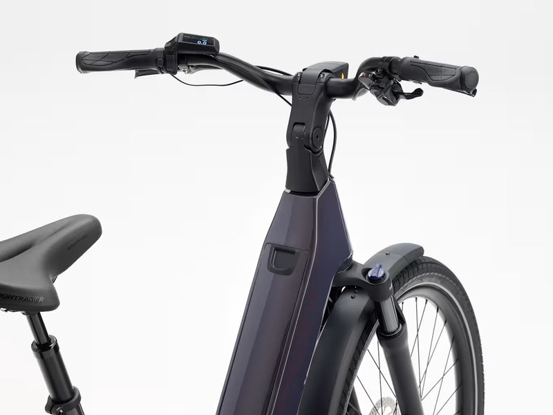 Close-up of an electric bicycle handlebar and frame, showing black grips, a digital display, and a dark metallic purple frame against a clean white background.