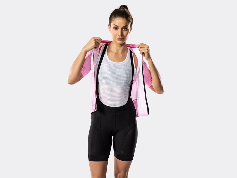 Bontrager Circuit women's black cycling bib shorts on model with cycling jersey, demonstrating low-profile bib straps, streamlined fit, and easy integration with cycling apparel for road riding.