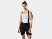 Bontrager Circuit women's black cycling bib shorts front view on model, featuring lightweight bib straps, supportive compression fit, ergonomic panel construction, sewn-in chamois design, and Bontrager logo above the right leg cuff.