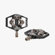 Pair of black and silver bicycle pedals on a white background