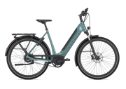 A low step electric bicycle in a muted teal frame with black components, fenders, and tires, shown from a side profile on a solid white background.