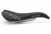 Selle SMP Dynamic Saddle side view with curved profile, white stitched logos, and central cutout, tip facing right.