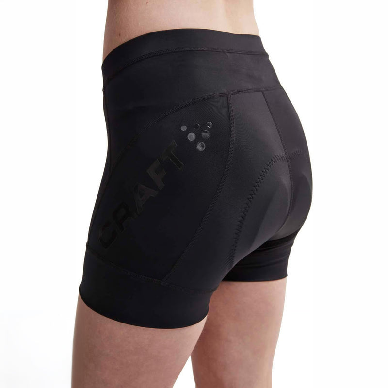 Craft Essence Hot Pants W black women’s cycling shorts in a three-quarter side view, featuring the mesh logo panel, waistband stitching and silicone leg gripper.