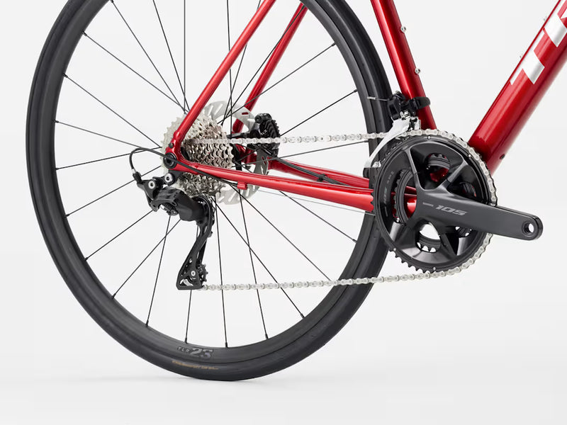 Close-up of a red bicycle's rear wheel and gear system on a white background