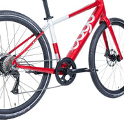 Close-up of the drive-side crank, pedal and drivetrain on the red Ebgo Modal Sport TB electric bike.