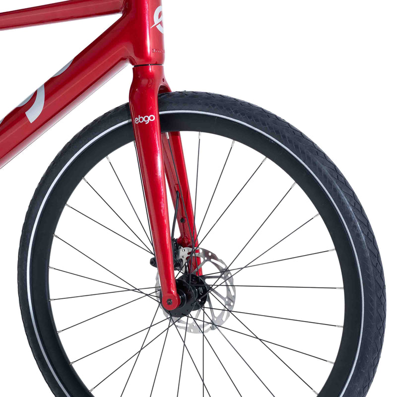 Close-up of the front wheel and CST tire on the red Ebgo Modal Sport TB electric bike.