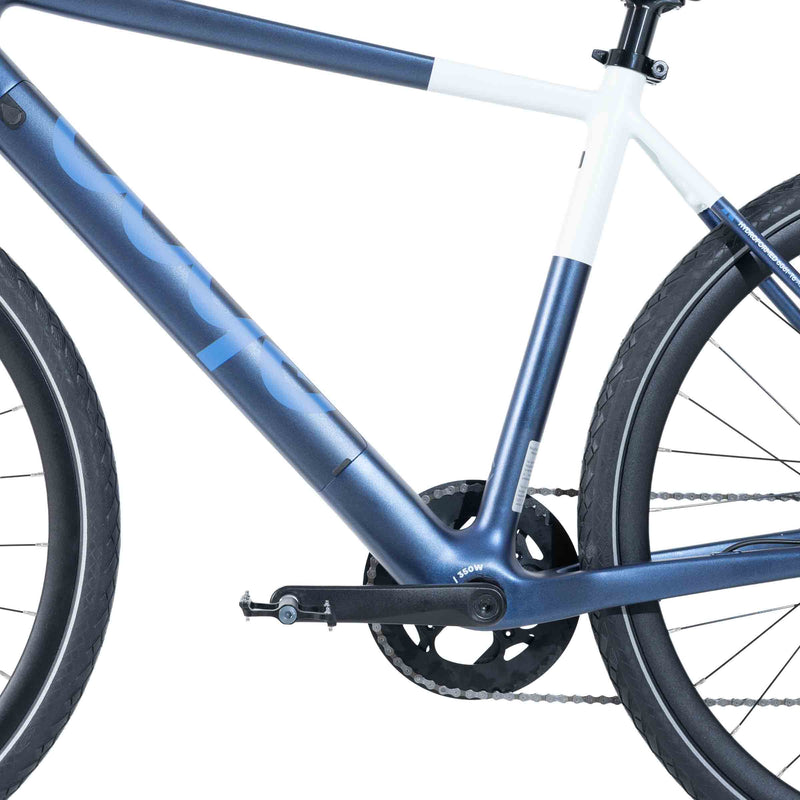 Close-up of the non-drive-side crank and pedal on the blue Ebgo Modal Sport TB electric bike.