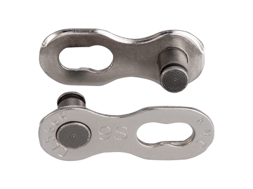 Two metallic bicycle chain links on a white background