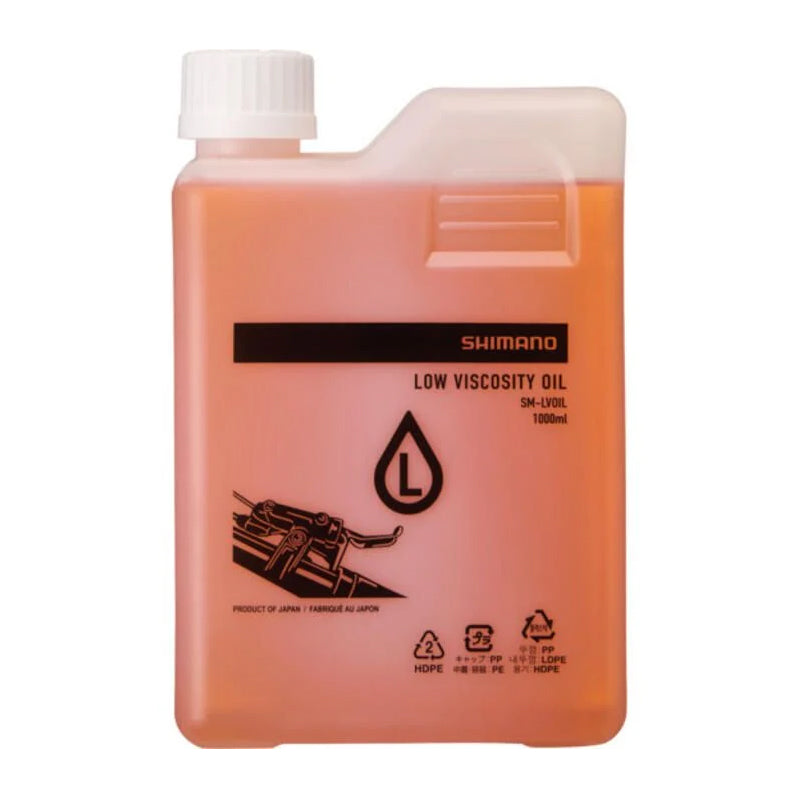 A 1-liter plastic bottle of Shimano low viscosity oil, filled with a translucent orange-pink liquid, featuring a white ribbed cap and black printed text and logo on the front.