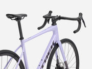 Purple endurance road bicycle with black components on a white background