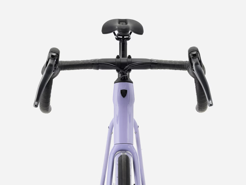 Front view of an endurance road bicycle with a light lavender-purple frame, black drop handlebars, black saddle, and black grips, shown against a solid light gray background.