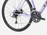 Close-up of an endurance road bicycle wheel and gear system on a white background