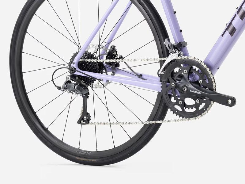 Close-up of an endurance road bicycle wheel and gear system on a white background