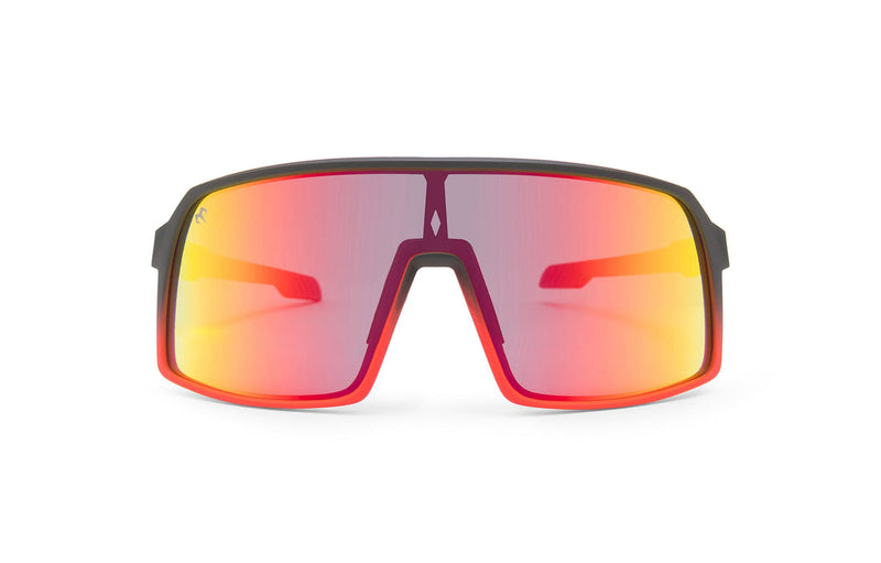 Carbon Black x Ruby sunglasses, front view with red frames, black stems with red ends and gradient lenses on a white background