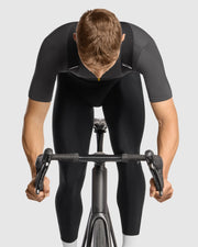 Person wearing a black cycling outfit on a white background