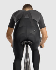 Person wearing a black cycling outfit on a white background