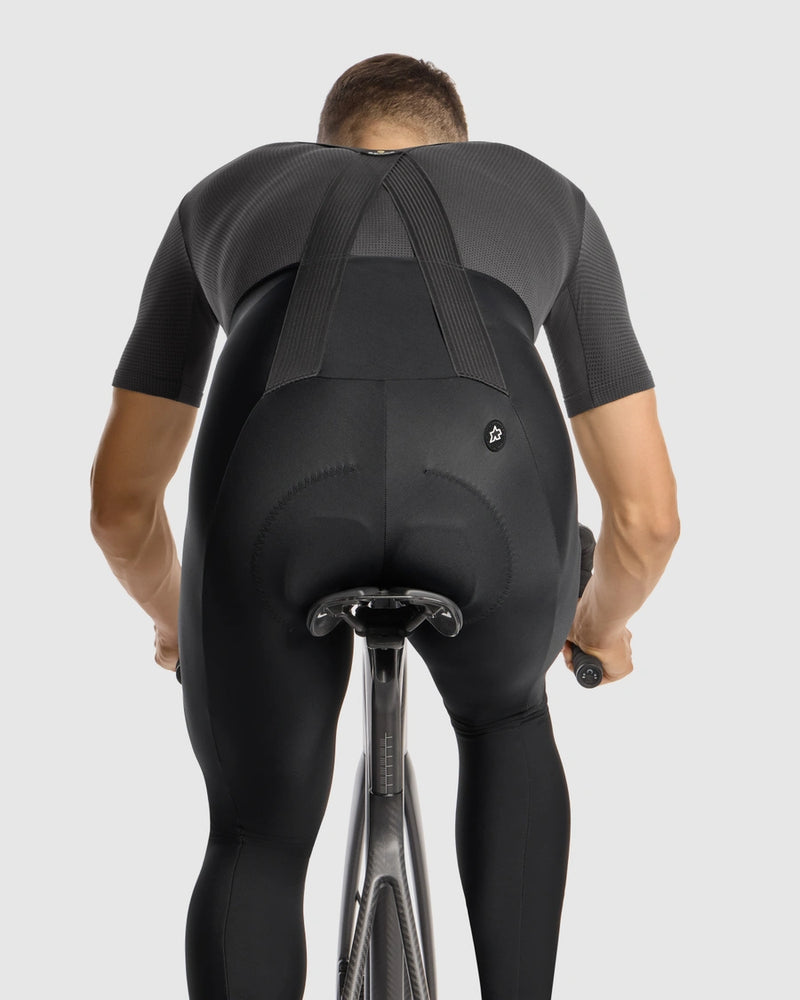 Person wearing a black cycling outfit on a white background