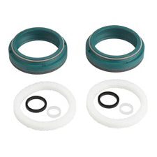 A set of bicycle or mechanical seals and O-rings, including two dark teal ring seals and two white rubber rings with black O-rings, shown on a plain white background.