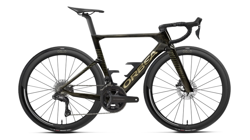 A high-end Orbea performance road bicycle in matte black with gold accents, featuring deep drop handlebars, carbon fiber wheels, and a sleek carbon frame, shown against a solid white background.