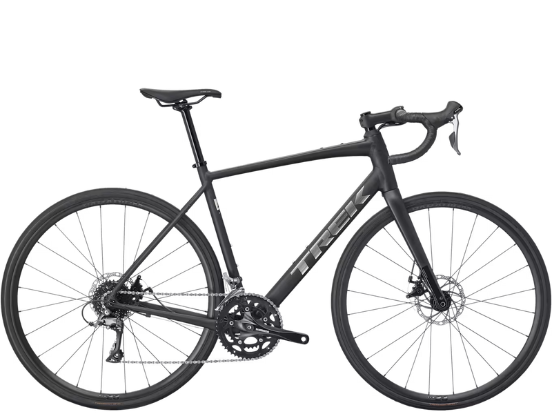 A dark gray Trek road endurance bicycle with drop handlebars, disc brakes, and a carbon fiber frame, shown from a side profile on a white background.