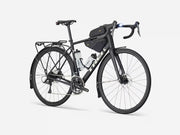 Black endurance road bicycle with gear packs on a white background