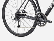 Close-up of a bicycle wheel and chain on a white background