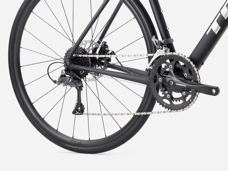 Close-up of a bicycle wheel and chain on a white background