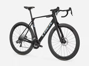 A black Trek road endurance bicycle with drop handlebars, carbon fiber wheels, and a sleek aerodynamic frame, shown from a three-quarters angle on a light gray background.