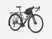 Black bicycle with gear packs on a white background