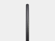 Bicycle tire with tread pattern on a light gray background