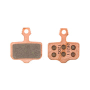 Two brake pads with metallic and rubber components on a white background