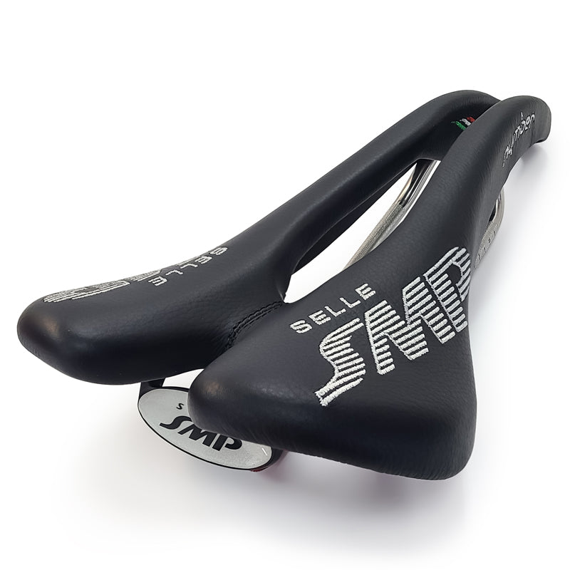 Product image of the Selle SMP Nymber Saddle in black leather with stitched SMP logo and central ergonomic cutout.