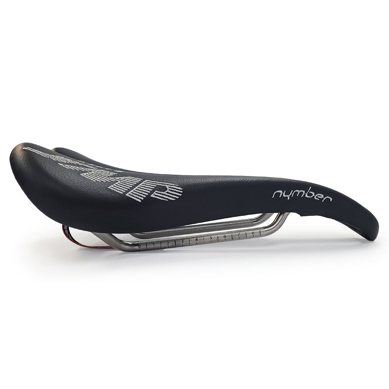 Product image of the Selle SMP Nymber Saddle in black leather with stitched SMP logo and central ergonomic cutout, diagonal view, where yuou can also see the product name 'nymber' in thast same stitching, side view.