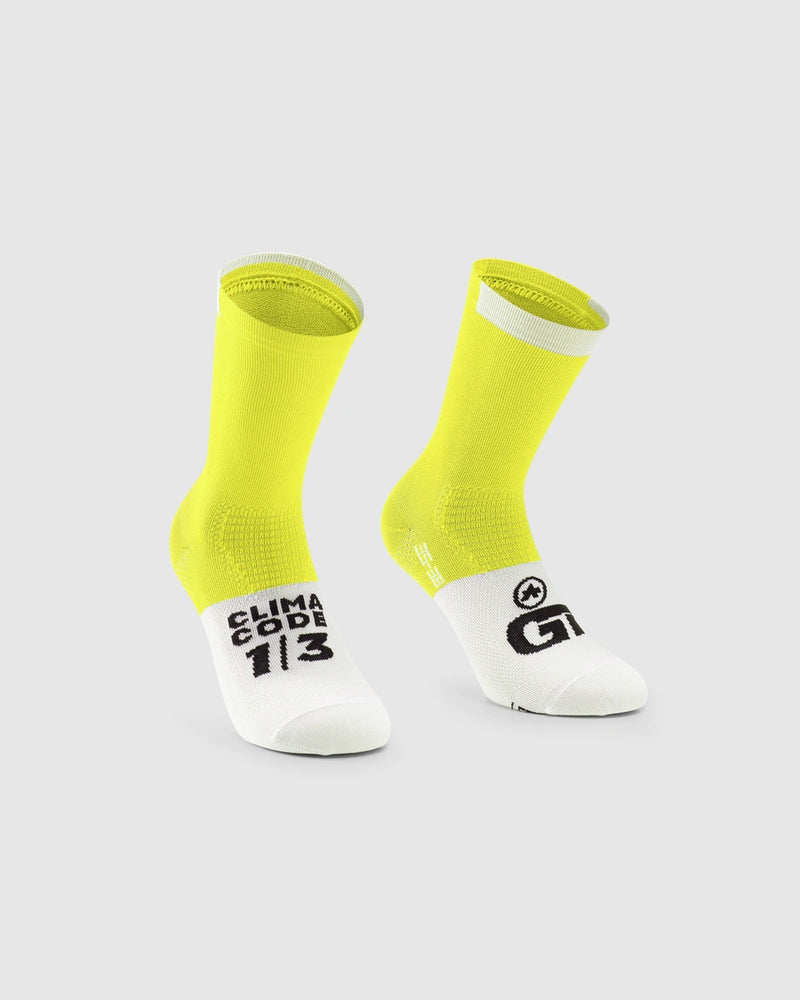 Yellow and white socks with visible branding on a light gray background