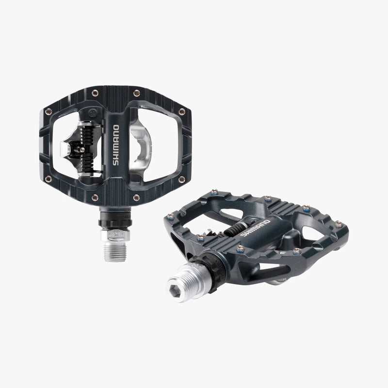 Two Shimano bicycle pedals on a white background
