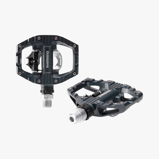 Two Shimano bicycle pedals on a white background