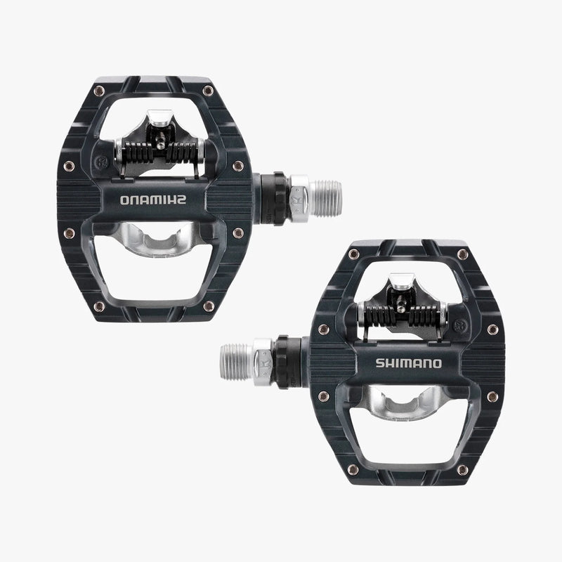 Two Shimano bicycle pedals on a white background