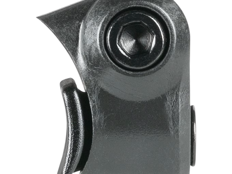 Close-up of a black metal mechanical component with a hexagonal fastener and curved lever, shown on a plain white background.