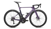 A purple and violet Orbea performance road bicycle with carbon fiber wheels, drop handlebars, and a carbon fiber fork, shown from a side profile on a white background.