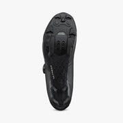 Bottom view of Shimano SH-XC503 ULTREAD rubber outsole showing lugged tread pattern, dual toe spike mounts, and recessed 2-bolt SPD cleat pocket