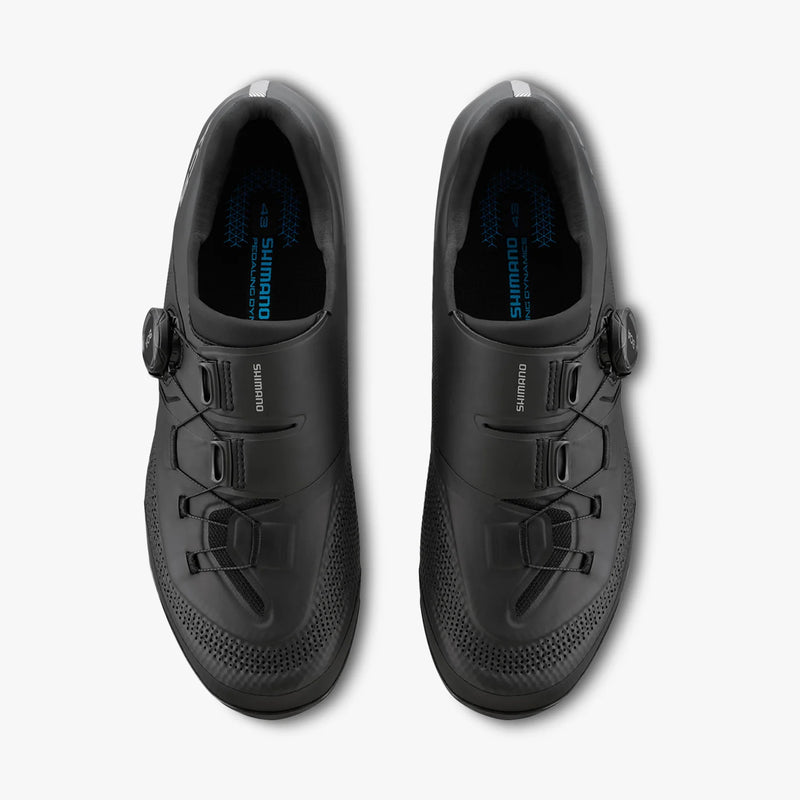 Top-down overhead view of paired black Shimano SH-XC503 shoes showing instep strap layout, ankle collar opening, and branded Shimano ergonomic footbed