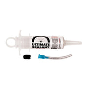 Ultimate Sealant bicycle tire sealant kit, featuring a clear plastic syringe-style tube with a white label, a small black cap, and a clear tube with a blue connector, shown on a white background.