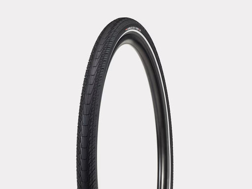 Black bicycle tire on a light gray background