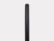 Black bicycle tire on a light gray background