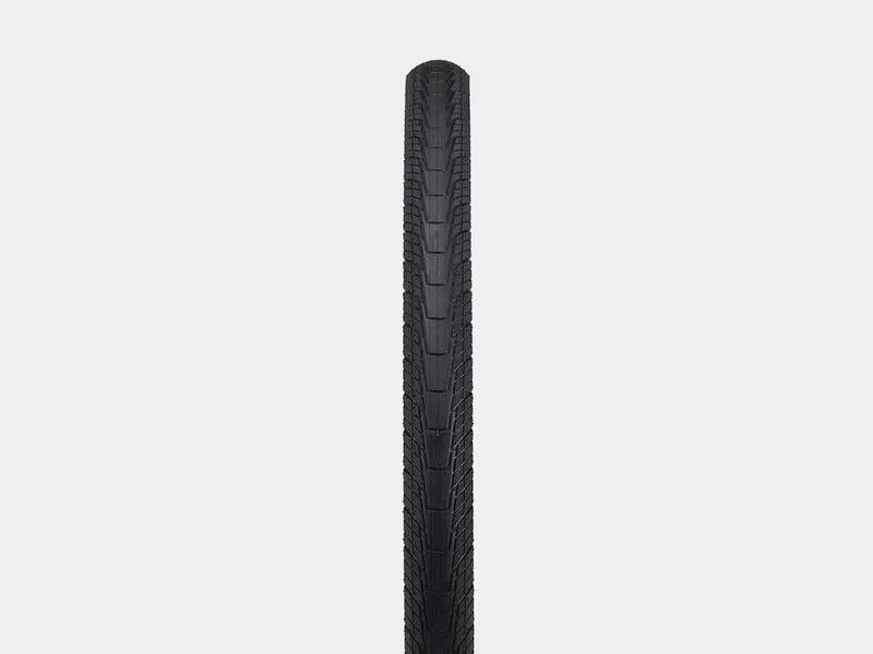Black bicycle tire on a light gray background