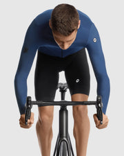 Person wearing a blue cycling suit on a white background