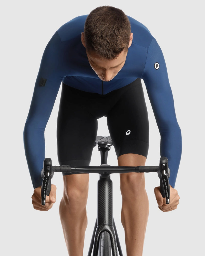 Person wearing a blue cycling suit on a white background