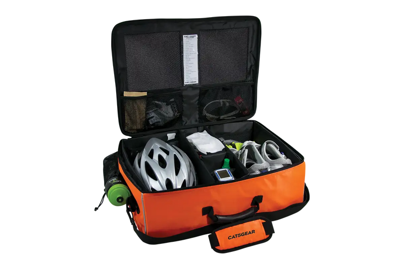 An open CAT5GEAR bicycle BAG with a bright orange exterior, black interior lining, and various CYCLING items organized inside, including a white bicycle helmet, a green bottle, shoes, gloves, shown on a white background.