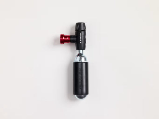 A Trek bicycle CO₂ inflater with a black body, red anodized valve, and silver metallic core, shown on a clean white background.